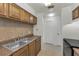 Kitchen with double sink and wood cabinets at 3455 Countryside Blvd # 34, Clearwater, FL 33761