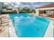 Community pool with patio and lounge chairs at 3455 Countryside Blvd # 34, Clearwater, FL 33761