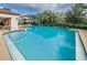 Community swimming pool with surrounding patio at 3455 Countryside Blvd # 34, Clearwater, FL 33761