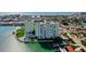 Condo complex with lush landscaping, community pool, and boat docks at 400 64Th Ave # 502, St Pete Beach, FL 33706