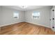 Bright bedroom with hardwood floors and two large windows at 400 64Th Ave # 502, St Pete Beach, FL 33706