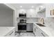 Modern white kitchen with marble counters and gold accents at 400 64Th Ave # 502, St Pete Beach, FL 33706