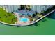 Community pool with sun loungers and tropical landscaping at 400 64Th Ave # 502, St Pete Beach, FL 33706