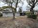 Home's backyard with shed and trees at 4108 W Oakellar Ave, Tampa, FL 33611