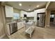 Modern kitchen with stainless steel appliances and white cabinets at 4108 W Oakellar Ave, Tampa, FL 33611