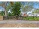 Red house with a black fence, landscaping, and a paved walkway at 4334 3Rd N Ave, St Petersburg, FL 33713