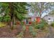 Quaint red house with a brick walkway, surrounded by mature trees and greenery at 4334 3Rd N Ave, St Petersburg, FL 33713