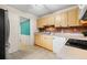 Galley kitchen, white appliances, wood cabinets at 4334 3Rd N Ave, St Petersburg, FL 33713