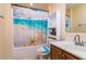 Clean bathroom with beach-themed shower curtain and updated vanity at 4533 Ashburn Square Dr # 4533, Tampa, FL 33610