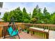 Wooden deck with swing and seating, overlooking trees at 4533 Ashburn Square Dr # 4533, Tampa, FL 33610