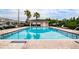 Community pool with lounge chairs and covered area at 4533 Ashburn Square Dr # 4533, Tampa, FL 33610