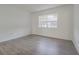 Bright bedroom with wood-look floors and window at 4715 Christa Ct # 334, Tampa, FL 33614