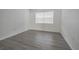 Bright bedroom with wood-look floors and window at 4715 Christa Ct # 334, Tampa, FL 33614