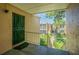 Apartment entryway with a green metal door and view of the courtyard at 4715 Christa Ct # 334, Tampa, FL 33614