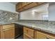 Kitchen featuring granite countertops and wooden cabinetry at 4715 Christa Ct # 334, Tampa, FL 33614