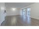 Bright living room featuring wood-look floors and sliding glass doors at 4715 Christa Ct # 334, Tampa, FL 33614