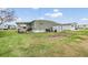 Backyard view of the home with shed and green space at 5322 Comanche St, Zephyrhills, FL 33542