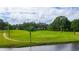 Golf course with palm trees and a pond at 5322 Comanche St, Zephyrhills, FL 33542