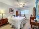 Cozy bedroom featuring a comfortable bed and wooden armoire at 5890 38Th N Ave # 101, St Petersburg, FL 33710