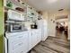 White kitchen with added shelving and counter space at 5890 38Th N Ave # 101, St Petersburg, FL 33710