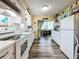 White kitchen with ample cabinetry, modern appliances, and a view of the breakfast nook at 5890 38Th N Ave # 101, St Petersburg, FL 33710