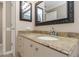 Bathroom features granite countertop, sink, and decorative mirror at 599 Centerwood Dr, Tarpon Springs, FL 34688