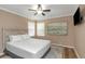 Bedroom with a queen bed, ceiling fan, and large art piece at 599 Centerwood Dr, Tarpon Springs, FL 34688