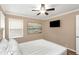 Bright bedroom with ceiling fan, large bed, and wall art at 599 Centerwood Dr, Tarpon Springs, FL 34688