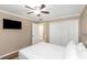 Bedroom with ceiling fan, double doors to closet, and TV at 599 Centerwood Dr, Tarpon Springs, FL 34688