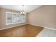 Spacious dining room featuring wood floors and large window at 599 Centerwood Dr, Tarpon Springs, FL 34688