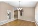 Simple dining room with wood flooring and neutral walls at 599 Centerwood Dr, Tarpon Springs, FL 34688