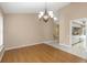 Bright dining room with wood floors and view to kitchen at 599 Centerwood Dr, Tarpon Springs, FL 34688