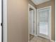 Hallway with door leading outside and additional door to bathroom at 599 Centerwood Dr, Tarpon Springs, FL 34688