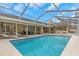 Expansive pool area with outdoor kitchen and patio furniture at 599 Centerwood Dr, Tarpon Springs, FL 34688