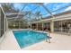 Relaxing screened pool and patio area with house view at 599 Centerwood Dr, Tarpon Springs, FL 34688