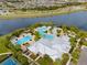 Aerial view showcasing the community pool, clubhouse, and meticulously manicured landscaping at 6307 Brevada Ln, Apollo Beach, FL 33572