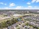 Aerial view of the neighborhood showcasing lush landscaping, community lakes and a residential area at 6307 Brevada Ln, Apollo Beach, FL 33572