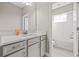 Well-lit bathroom featuring a modern vanity with a granite countertop and a view of an additional bath at 6307 Brevada Ln, Apollo Beach, FL 33572