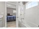 Bright bathroom with a tub, a shower curtain with children patterns, and tile surround at 6307 Brevada Ln, Apollo Beach, FL 33572