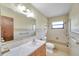 Clean bathroom with beige tile and a bathtub at 6327 5Th Street E Cir, Bradenton, FL 34203