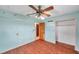 Bedroom with wood-look floors and ceiling fan at 6327 5Th Street E Cir, Bradenton, FL 34203