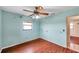 Bedroom with wood-look floors and ceiling fan at 6327 5Th Street E Cir, Bradenton, FL 34203