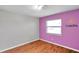 Simple bedroom with wood floors and purple accent wall at 6327 5Th Street E Cir, Bradenton, FL 34203