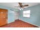 Bedroom with wood-look floors, closet, and ceiling fan at 6327 5Th Street E Cir, Bradenton, FL 34203