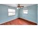 Bedroom with wood-look floors, ceiling fan, and window at 6327 5Th Street E Cir, Bradenton, FL 34203