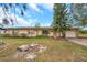 Single-story house with a brown roof, stone accents, and a spacious yard at 6327 5Th Street E Cir, Bradenton, FL 34203