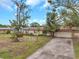 Single-story home with a large yard and a covered roof at 6327 5Th Street E Cir, Bradenton, FL 34203