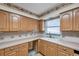 Kitchen with wood cabinets, tiled floors, and a sink at 6327 5Th Street E Cir, Bradenton, FL 34203