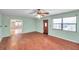 Bright living room featuring wood-look floors and a view into the dining area at 6327 5Th Street E Cir, Bradenton, FL 34203