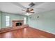 Spacious living area with hardwood floors, a brick fireplace and ceiling fan at 6327 5Th Street E Cir, Bradenton, FL 34203